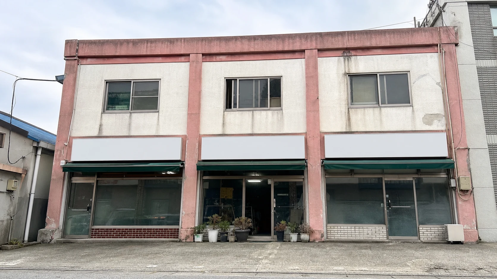 A weathered commercial exterior before repainting